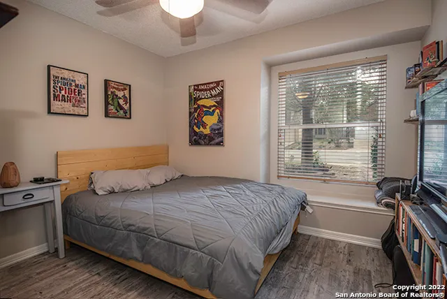 a bedroom with a bed and a large window with the outer view