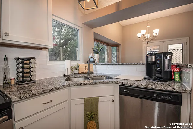 a kitchen with stainless steel appliances granite countertop a sink stove and cabinets