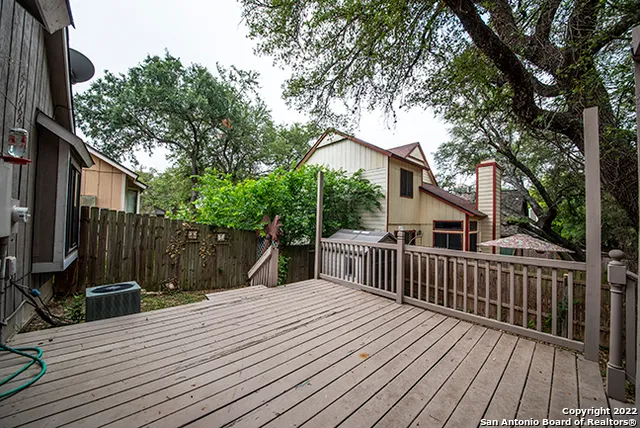 a view of backyard with a deck and wooden floor