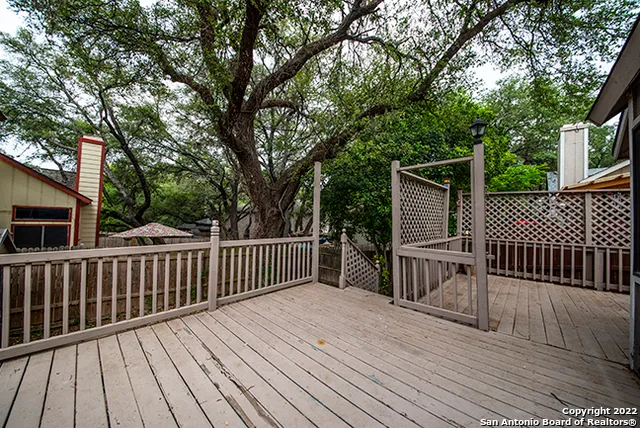 a balcony with wooden floor and fence