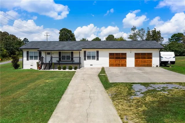 a front view of a house with a garden and patio