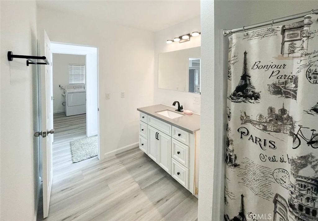 13517 Franklin Street Whittier, CA 90602 - Photo 11 of 22 a bathroom with a double vanity sink a large mirror and shower