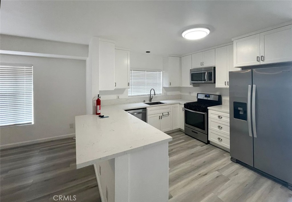 13517 Franklin Street Whittier, CA 90602 - Photo 5 of 22 a kitchen with stainless steel appliances a refrigerator sink and cabinets