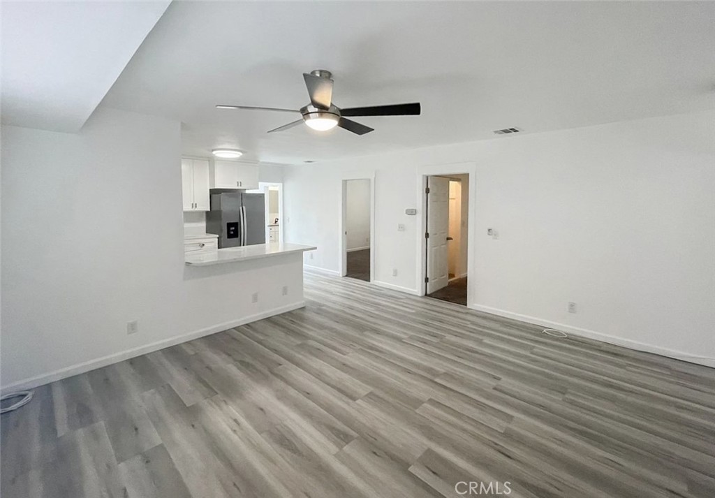 13517 Franklin Street Whittier, CA 90602 - Photo 8 of 22 wooden floor in an empty room with a kitchen