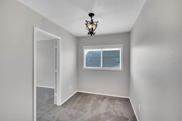 a view of an empty room with a ceiling fan