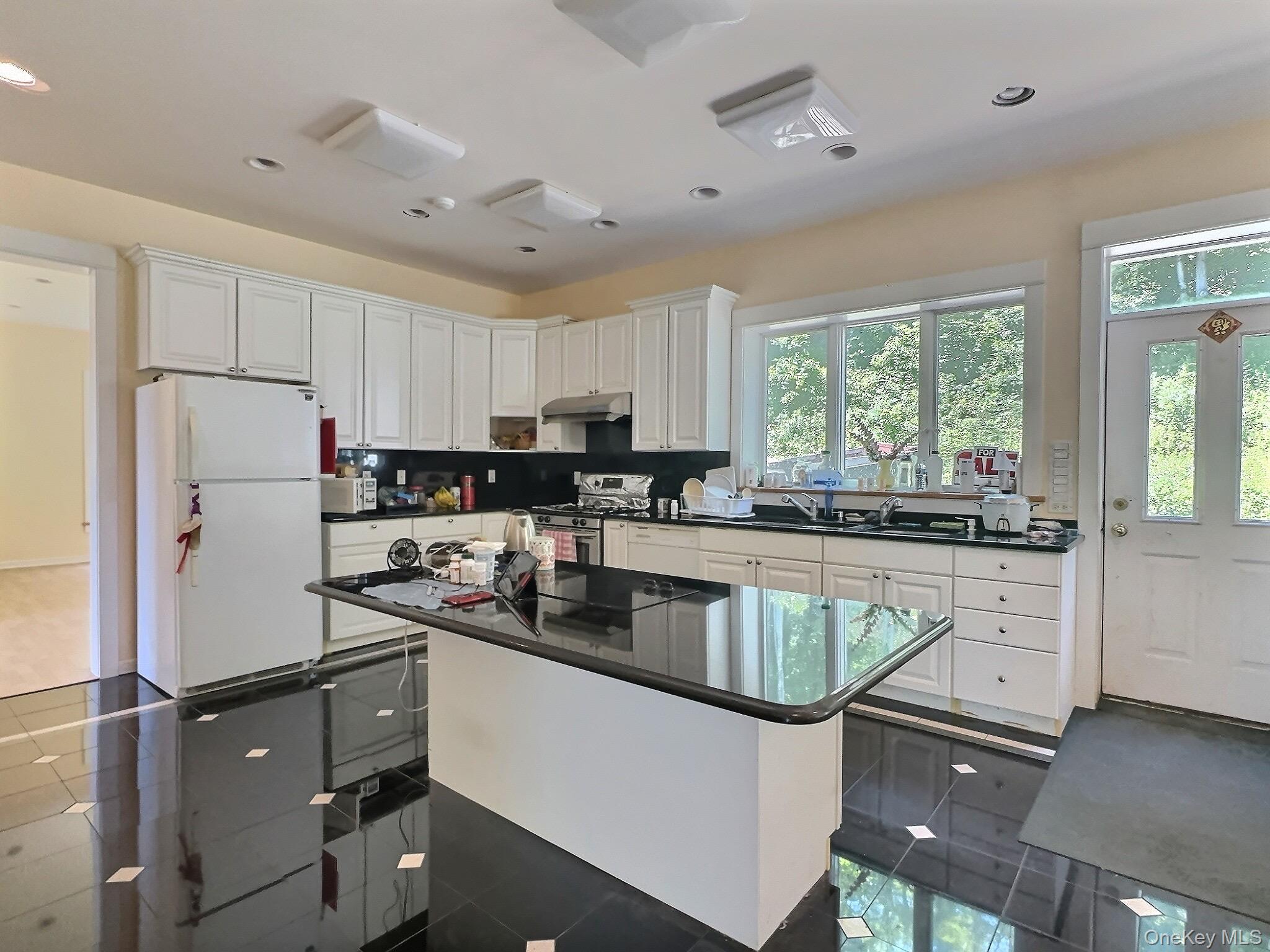 118 Scenic Ridge Drive Brewster, NY 10509 - Photo 16 of 50 a kitchen with refrigerator cabinets and a counter top space