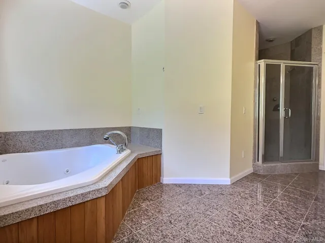 a bathroom with a tub and shower