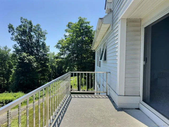 a view of balcony with wooden floor and fence