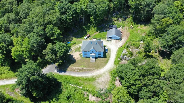 an aerial view of a house with outdoor space