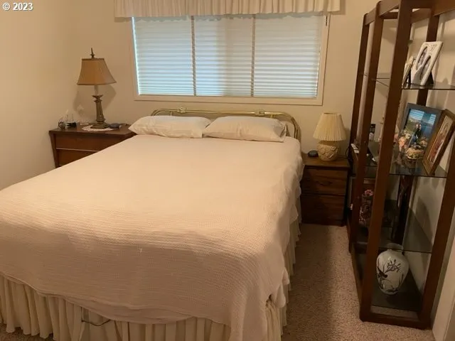 a bed sitting in a bedroom next to a window
