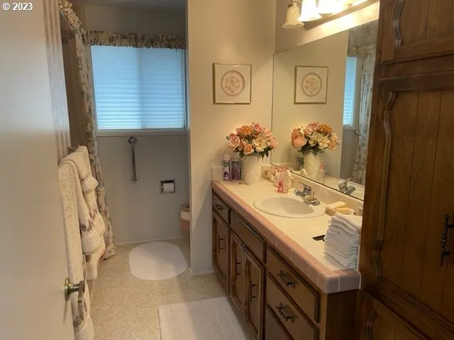 a bathroom with a sink a toilet and a mirror