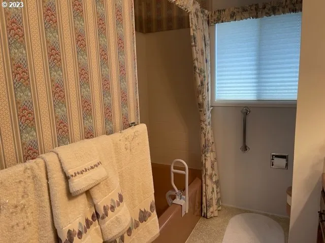 a bathroom with a bathtub and shower