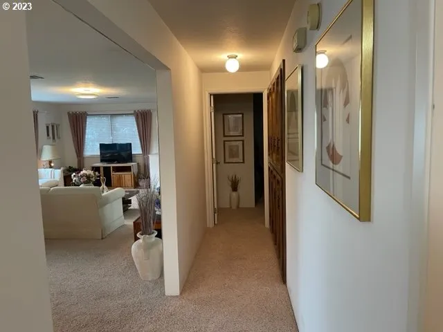 a view of a hallway view with living room and dining room
