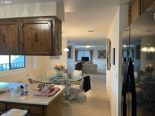 a kitchen with a sink refrigerator and cabinets