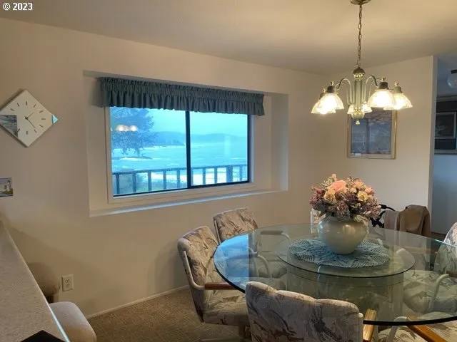 a dining room with furniture and chandelier