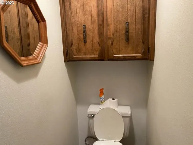 a view of a house with pool and wooden fence