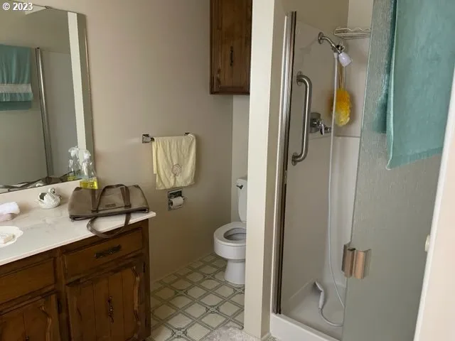 a bathroom with a granite countertop sink toilet and shower
