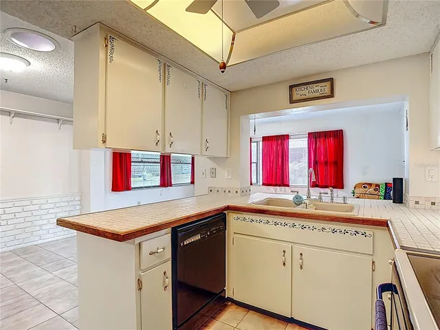 a kitchen that has a sink and a stove in it