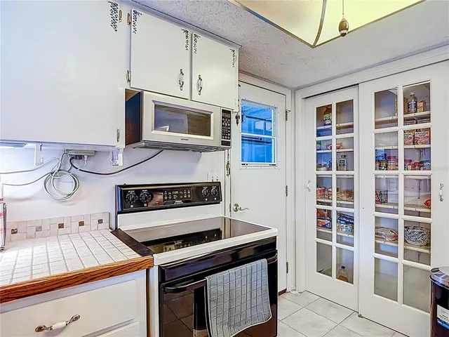 a room with gym equipment with wooden floor