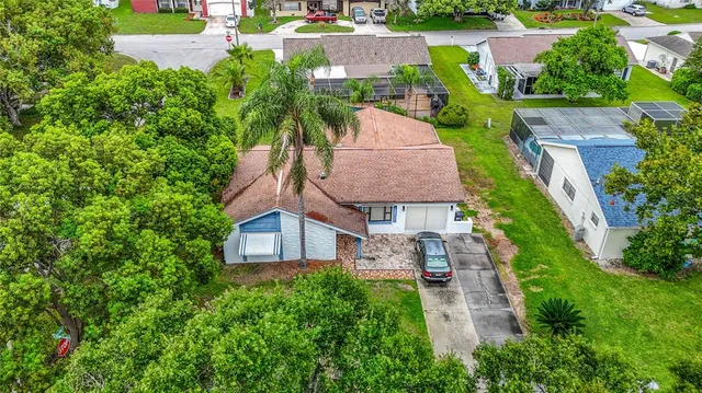 an aerial view of a house with garden space and street view