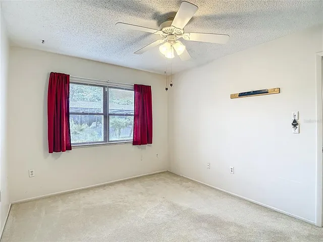 a bathroom with a granite countertop bathtub sink vanity mirror and toilet