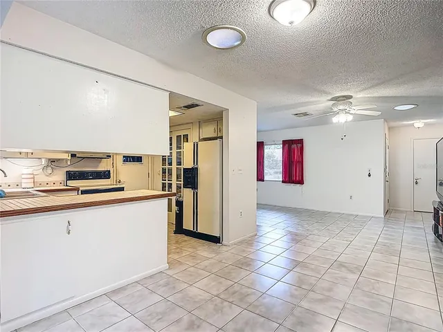a kitchen with granite countertop a sink cabinets and stainless steel appliances