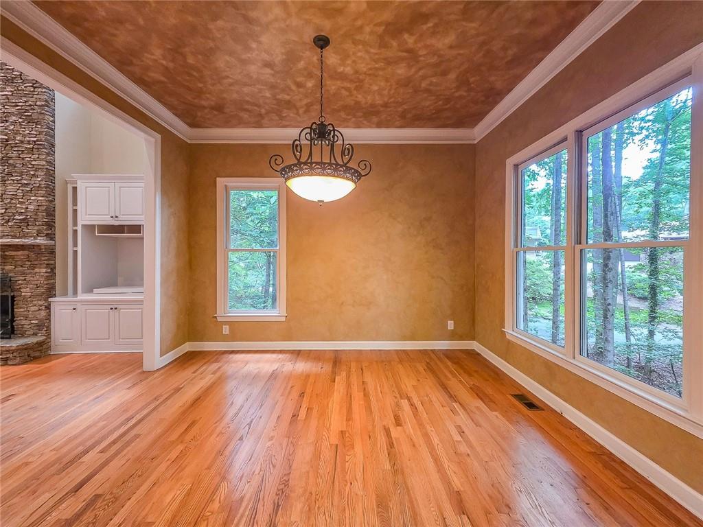3712 Frederica Road Northwest Berkeley Lake, GA 30096 - Photo 10 of 49 a view of empty room with wooden floor and fan