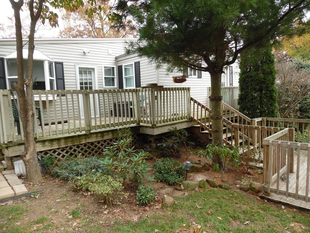 61 Helberg Road Springfield, MA 01128 - Photo 23 of 30 a view of a house with a small yard and wooden fence