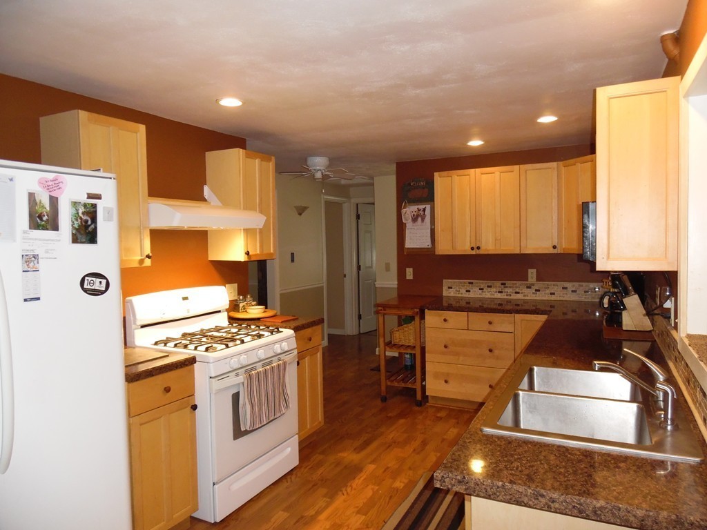 61 Helberg Road Springfield, MA 01128 - Photo 9 of 30 a kitchen with stainless steel appliances granite countertop a stove a sink and a refrigerator