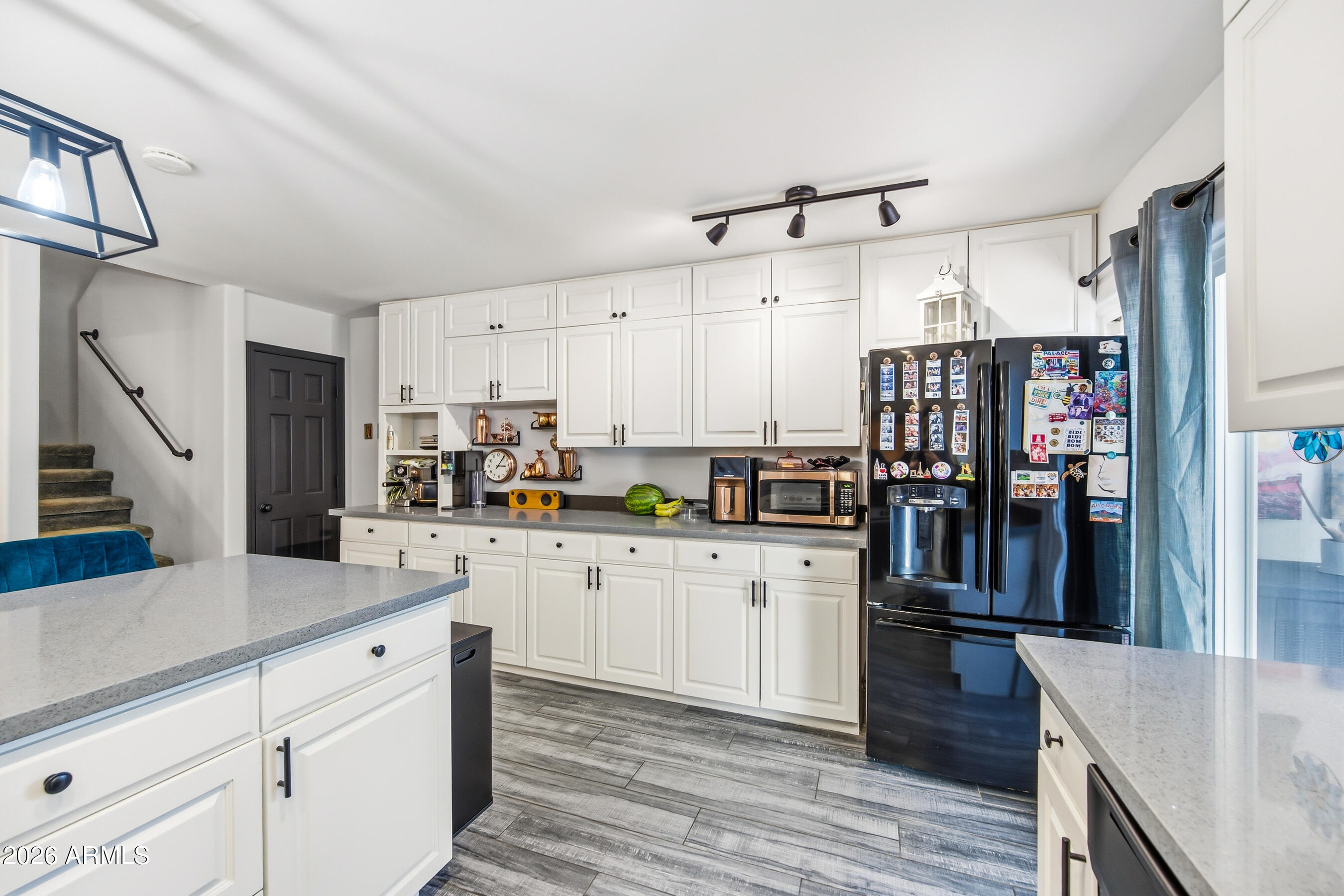 1702 East Ocotillo Road, Unit 1 Phoenix, AZ 85016 - Photo 12 of 27 a kitchen with stainless steel appliances kitchen island granite countertop a refrigerator a stove and white cabinets with wooden floor