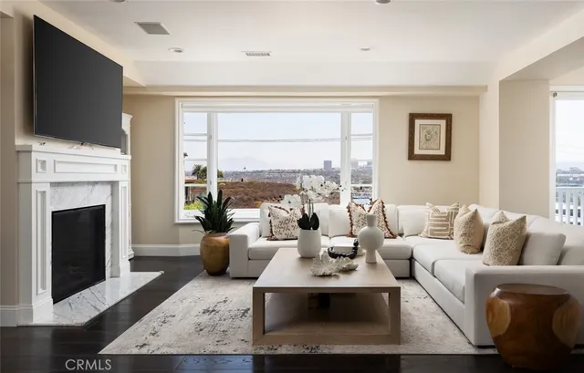 a living room with furniture a fireplace and a flat screen tv