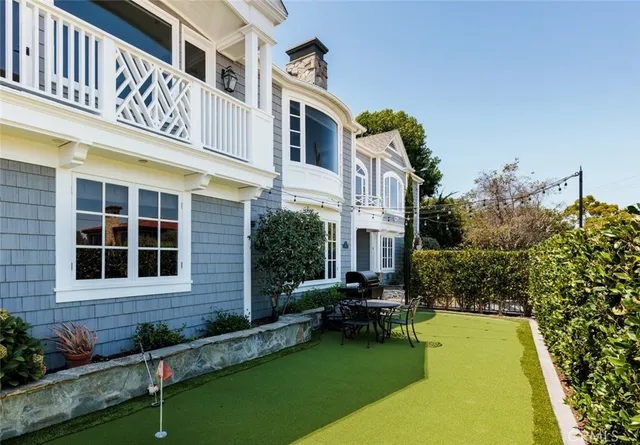 a view of an entryway with wooden floor couches and a dining table