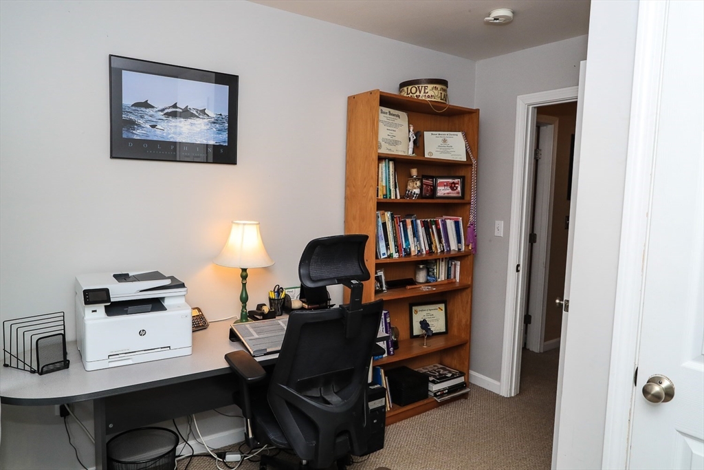 25 Flying Rock Road Hudson, NH 03051 - Photo 23 of 33 a view of a workspace with bookshelf and a workspace