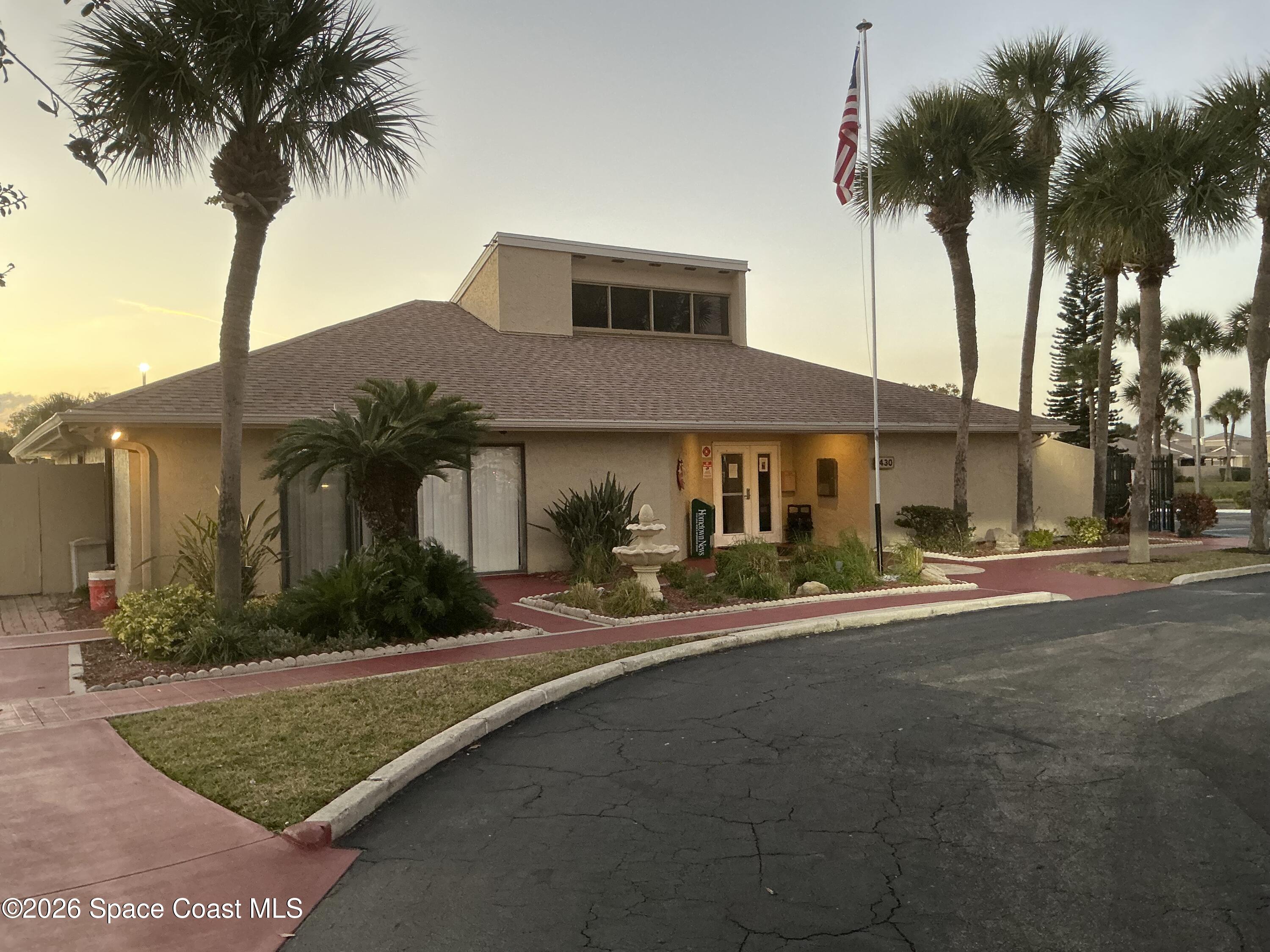 1470 Sheafe Avenue Northeast, Unit 106 Palm Bay, FL 32905 - Photo 13 of 16 a front view of a house with a garden and a yard