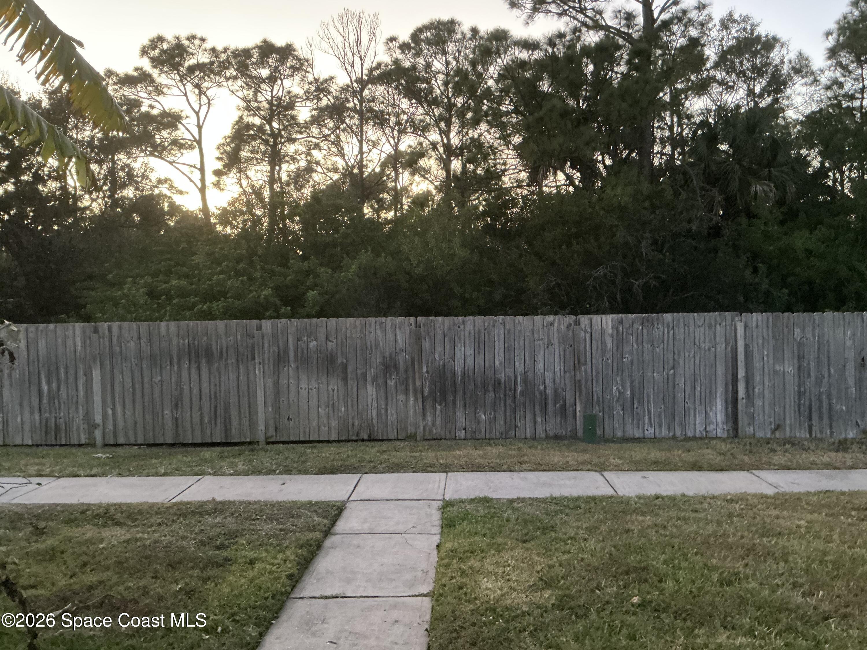 1470 Sheafe Avenue Northeast, Unit 106 Palm Bay, FL 32905 - Photo 2 of 14 a view of outdoor space with wooden fence