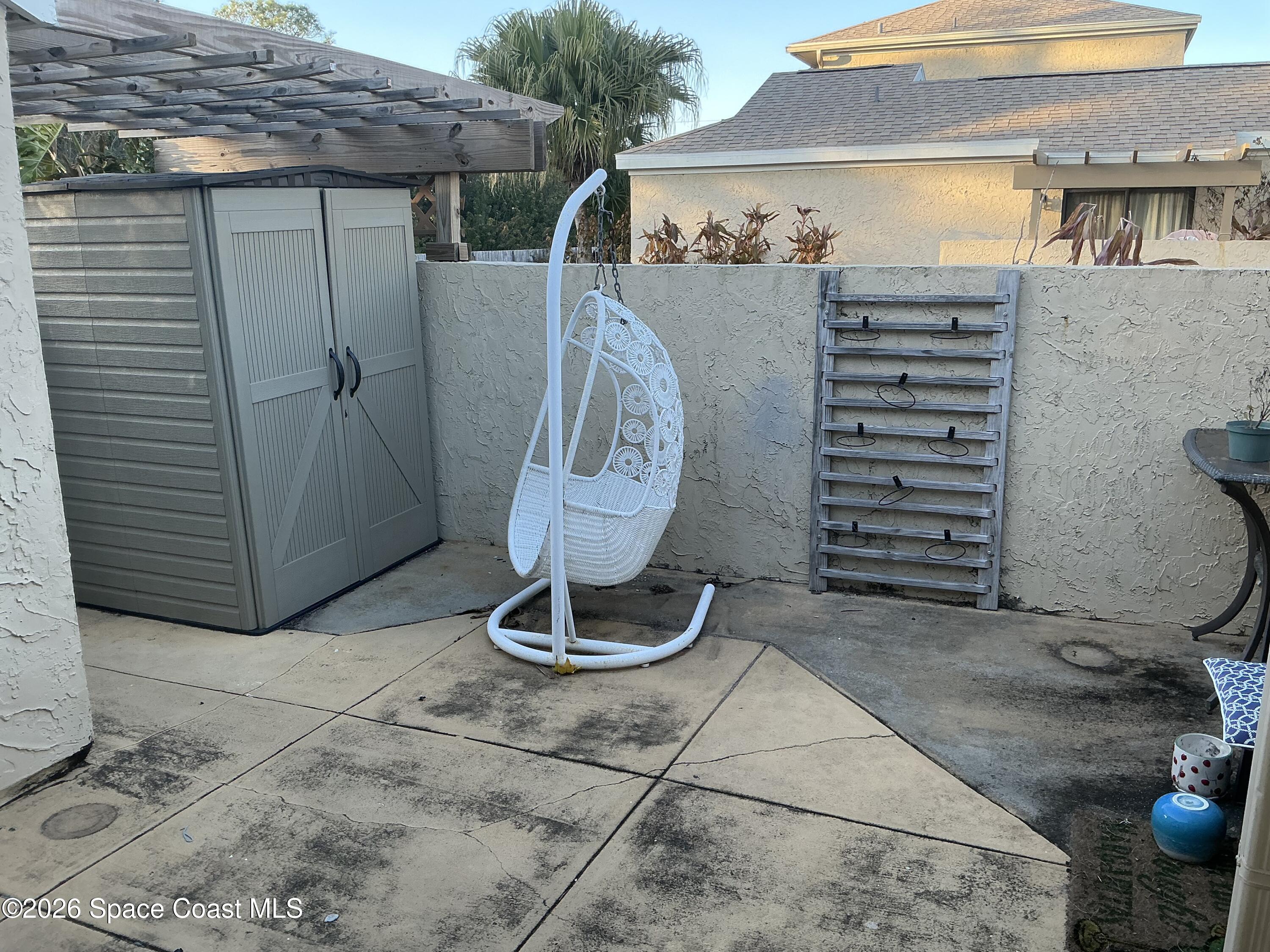 1470 Sheafe Avenue Northeast, Unit 106 Palm Bay, FL 32905 - Photo 4 of 16 a view of a two chair in the patio