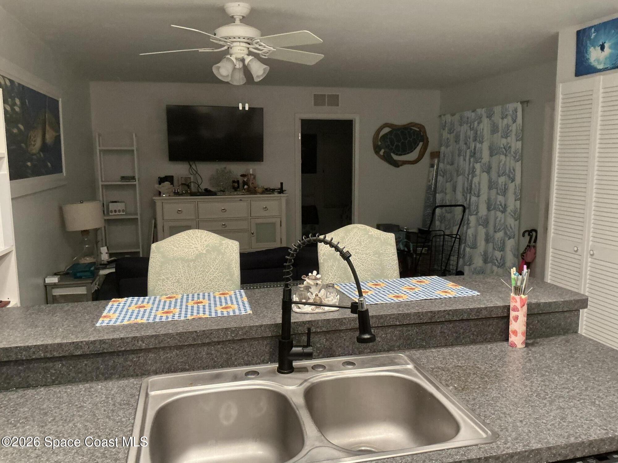 1470 Sheafe Avenue Northeast, Unit 106 Palm Bay, FL 32905 - Photo 5 of 14 a living room with furniture and a flat screen tv