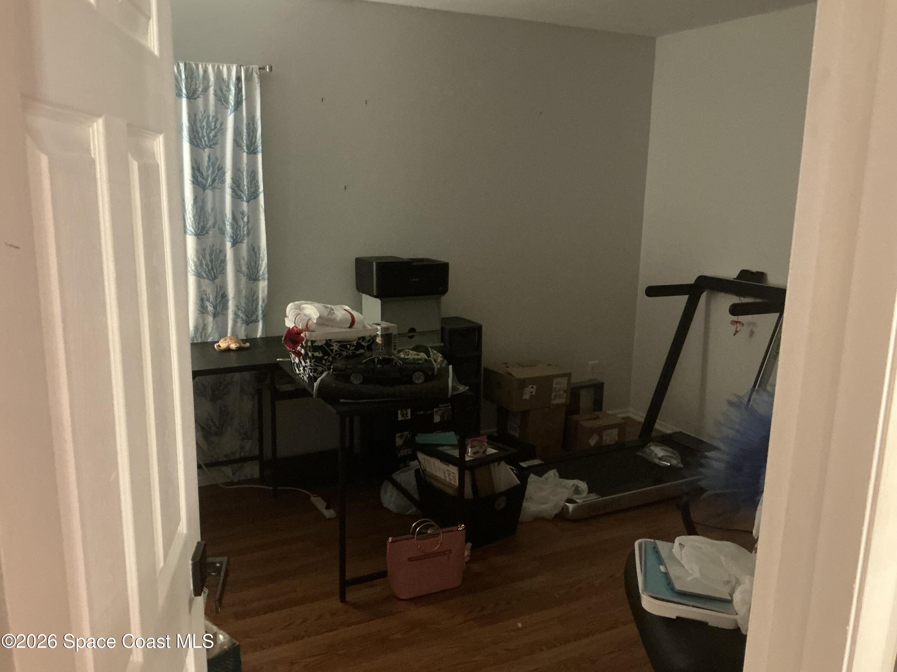 1470 Sheafe Avenue Northeast, Unit 106 Palm Bay, FL 32905 - Photo 9 of 14 a view of a workspace with furniture and a window