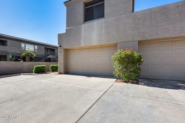a front view of a house with a yard and a garage