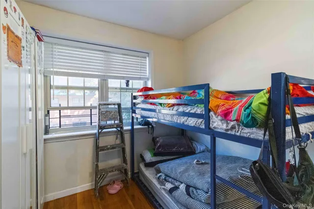 a utility room with stainless steel appliances furniture and a window