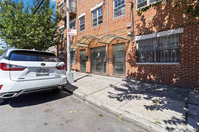 a view of a cars park in front of a building