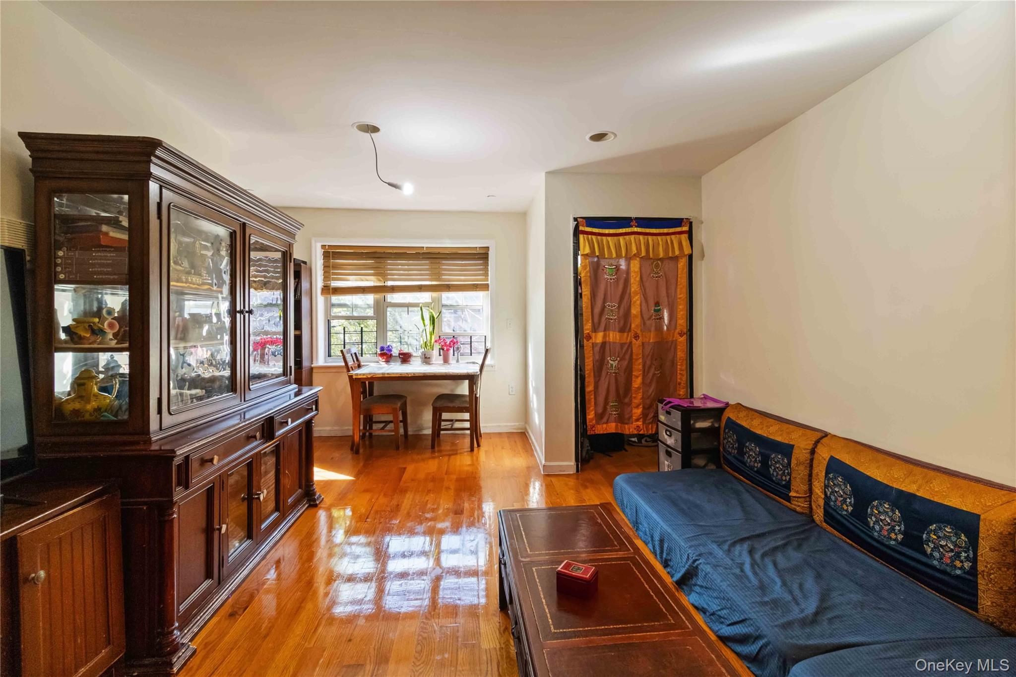 10223 43rd Avenue, Unit 2B Queens, NY 11368 - Photo 10 of 15 a living room with furniture and a wooden floor