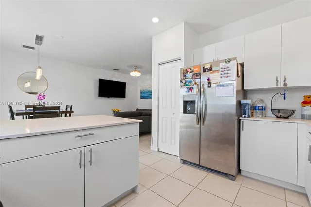 a kitchen with a refrigerator and a sink