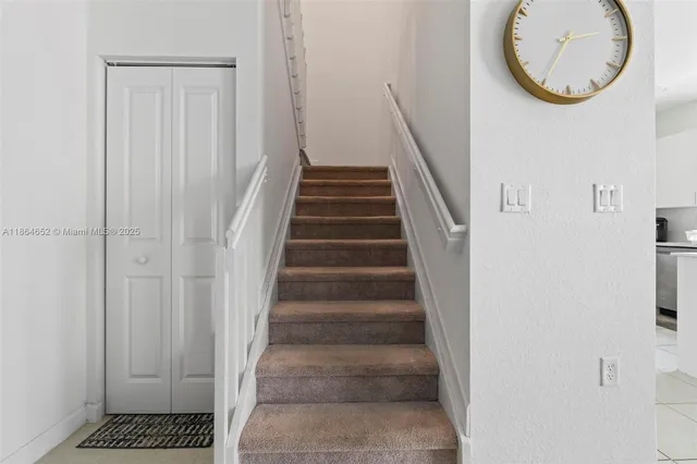 a view of a hallway with wooden floor and entryway