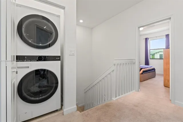 a view of a hallway with washer and dryer