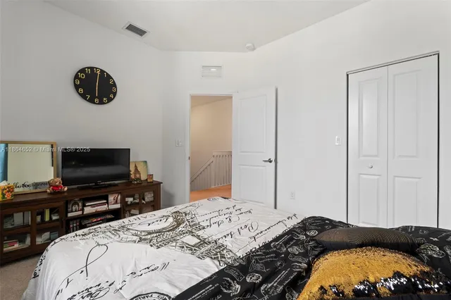 a bedroom with a bed and a television