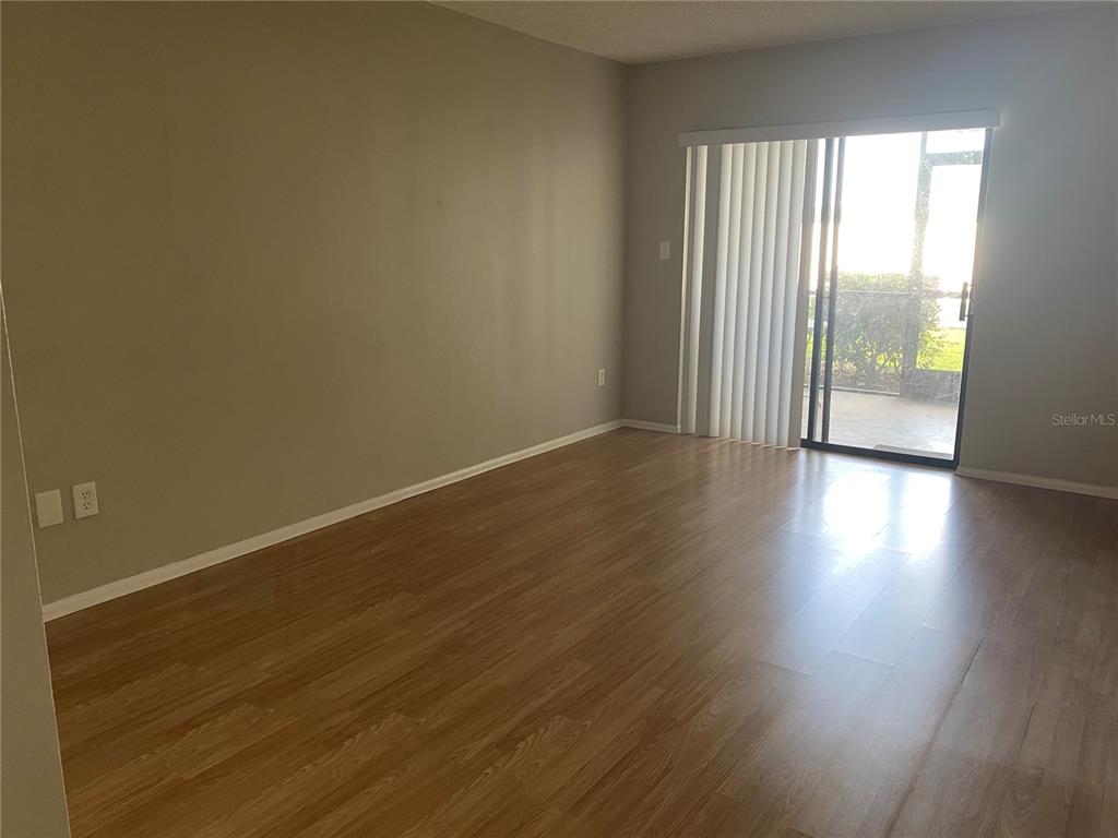 4400 Castlepalm Road Orlando, FL 32839 - Photo 14 of 38 an empty room with wooden floor and windows