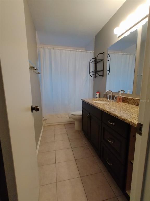 4400 Castlepalm Road Orlando, FL 32839 - Photo 16 of 38 a bathroom with a sink a toilet and mirror