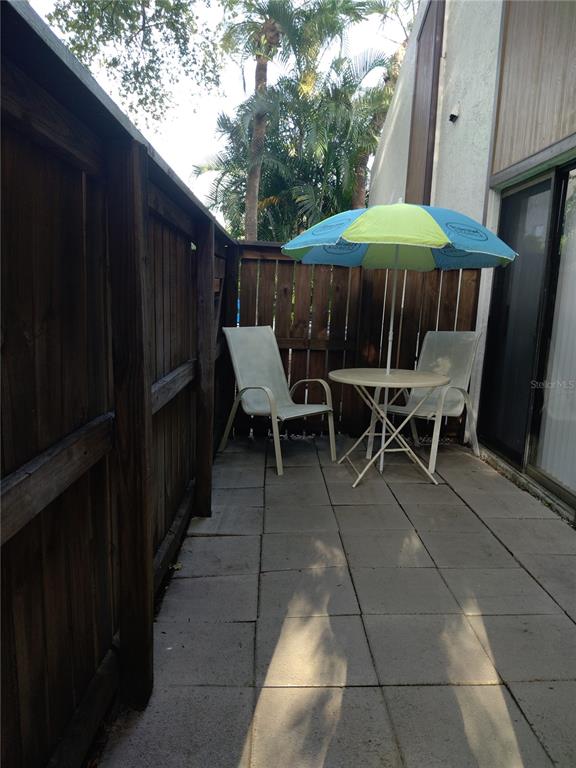 4400 Castlepalm Road Orlando, FL 32839 - Photo 23 of 38 a view of backyard with outdoor seating and wooden fence