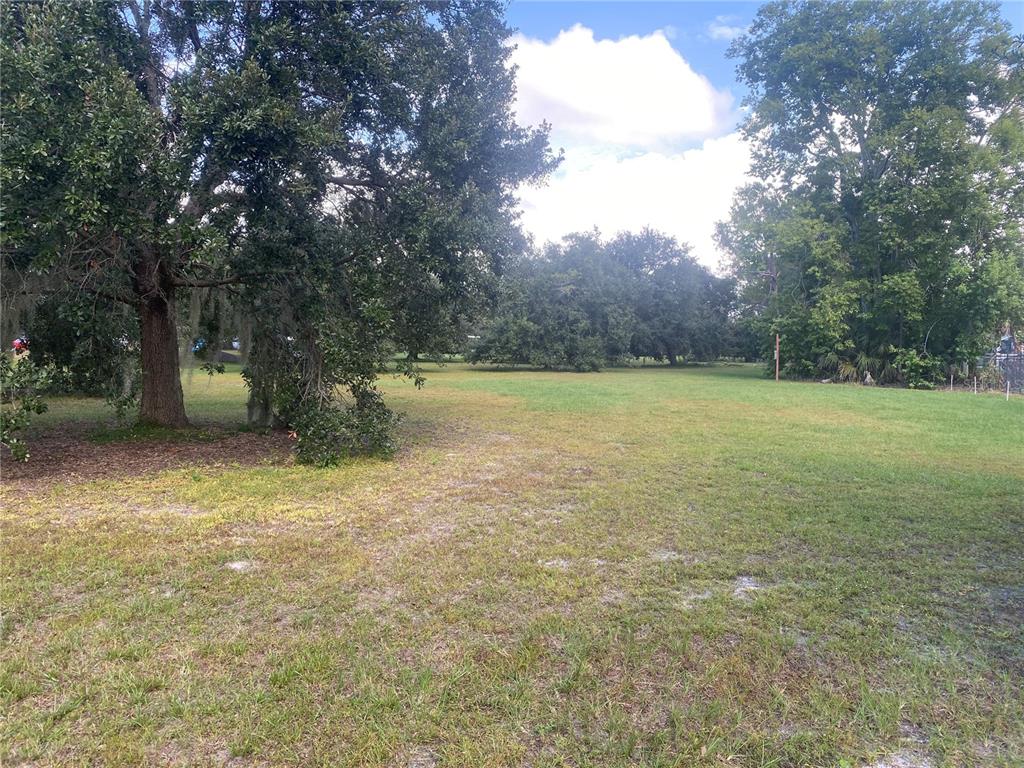 4400 Castlepalm Road Orlando, FL 32839 - Photo 30 of 38 a view of a field with trees in the background